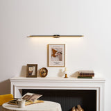 Slim rod lit above a white mantel with framed prints and books on a shelf