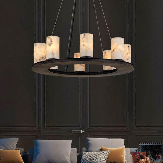 The lit ring in a dark room above a sofa with cushions and paneled walls