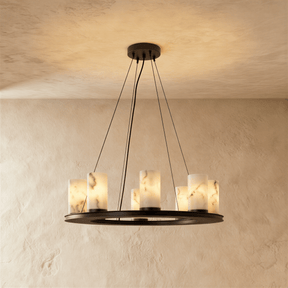 A black ring carrying eight alabaster cylinders, lit, on three cables