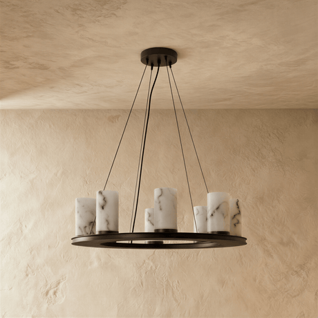 The same black ring with its eight stone cylinders unlit on a plaster wall
