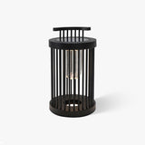 Black cylindrical lantern with close vertical bars around a clear tube