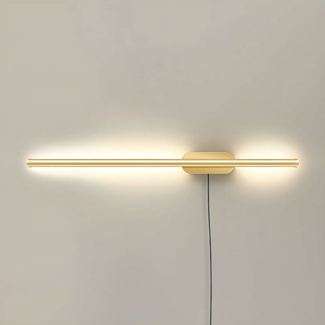 The slim gold profile lit, a narrow band of light across a pale wall