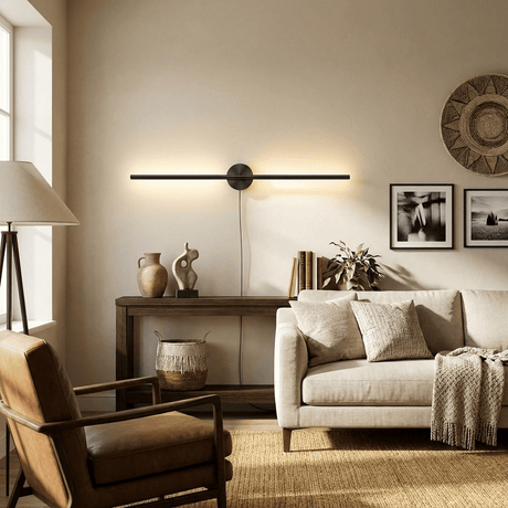 Black bar lit above a sideboard of pottery and framed prints beside two armchairs