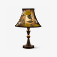 Black table lamp with an embroidered shade on a turned wood stem, plain background