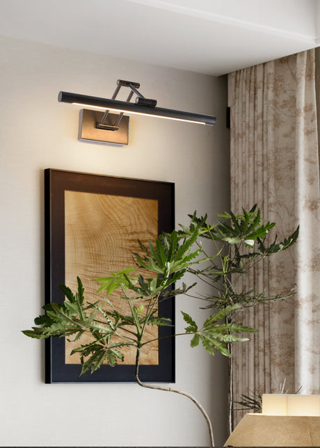 Black bar lit above a large framed panel beside a curtain and a leafy plant