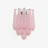 Wall sconce of layered pink textured glass petals falling in three tiers