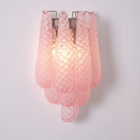 The pink sconce lit, the textured petals glowing