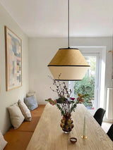 Willow pendant lit in an interior beside a window