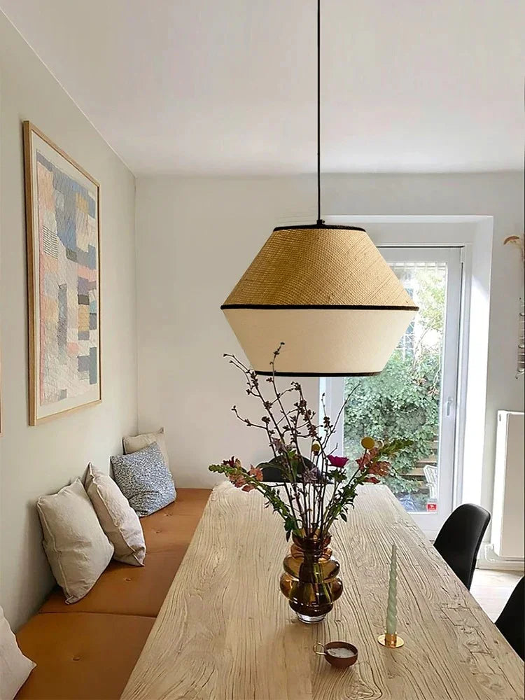 Willow pendant lit in an interior beside a window