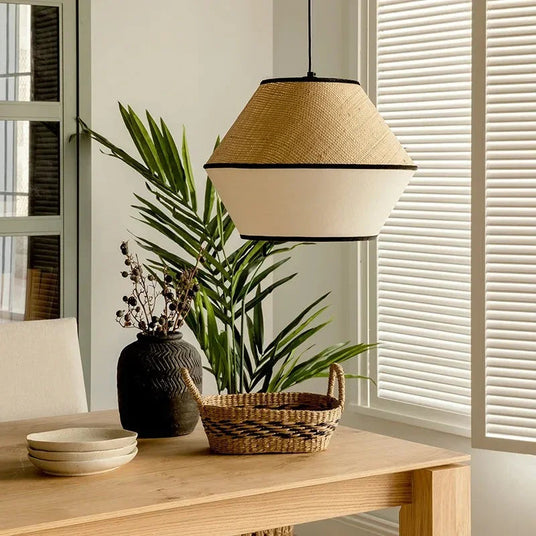 Woven willow pendant hung in a room with pale walls