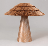 Boho table lamp in natural straw seen from the front, plain background