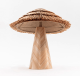 The straw shade seen from below, the frame visible inside the tiers