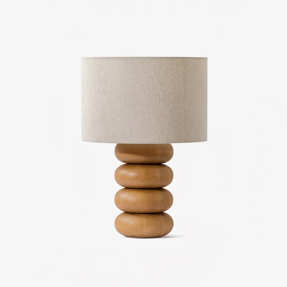Table lamp with three stacked flattened wood spheres and a linen drum shade