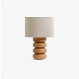 Stacked wood sphere table lamp seen slightly from above, shade unlit