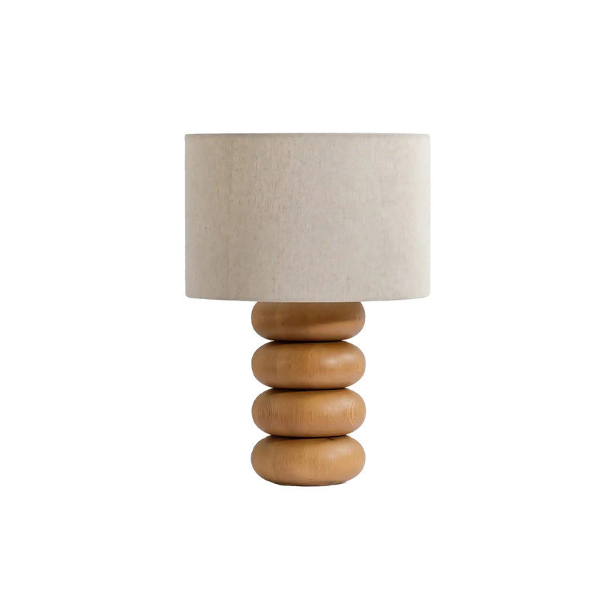 Unlit stacked wood sphere table lamp against a plain pale ground