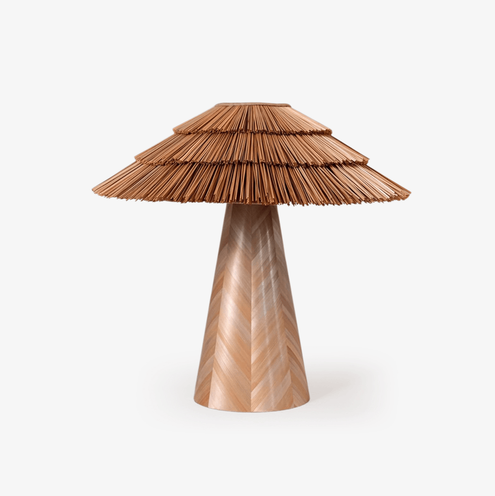 Boho table lamp with a tiered straw shade on a wood cone, plain background
