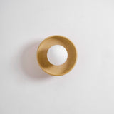 The sconce seen from an angle, showing the depth of the ceramic bowl