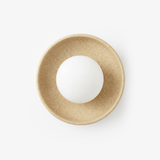 Round ceramic wall light with a speckled sand glaze bowl around an opal white glass globe