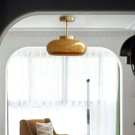 The yellow dome lit beside an arched window with an armchair below it