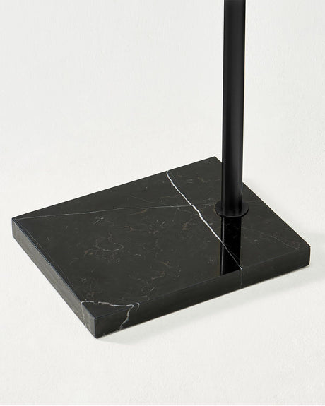 The black pole set into the same black marble slab, seen from the side
