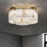 Alabaster panel ceiling light lit against a dark plaster ceiling