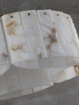 Close view of the lower row of alabaster panels and the brass pins