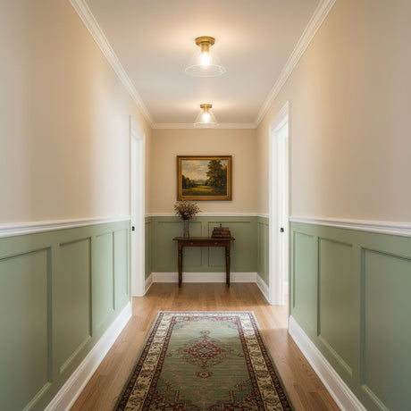 Brass ceiling lights along a corridor with green paneling and a runner
