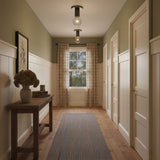 Black ceiling lights in a corridor with olive walls and a dark wood floor