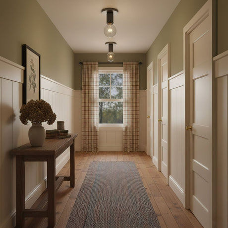 Black ceiling lights in a corridor with olive walls and a dark wood floor