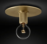 Brass ceiling light with a globe shade seen from below against a dark backdrop
