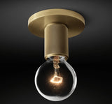 Brass ceiling light with a globe shade lit against a dark backdrop