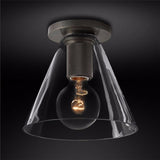 Black ceiling light with a clear cone shade against a dark backdrop