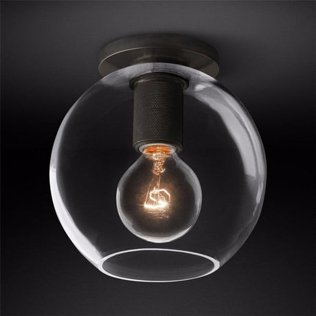 Black ceiling light with a clear globe shade against a dark backdrop