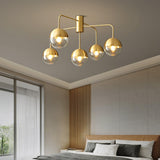 Five globe brass ceiling light in a bedroom with slatted wall panels