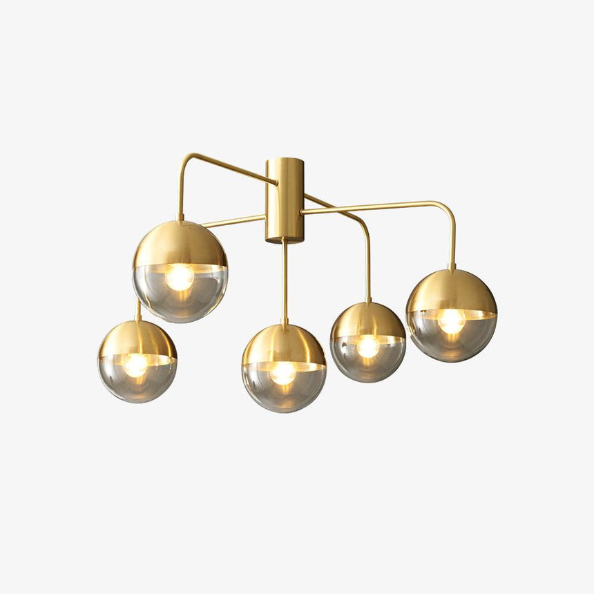 Five globe brass ceiling light seen from the side on a pale backdrop
