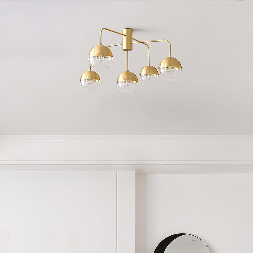 Five globe brass ceiling light seen from below on a white ceiling