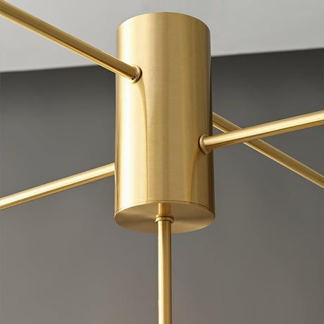 Close view of the central brass column where the arms meet