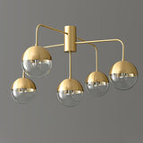 Five globe brass ceiling light lit and seen from the side