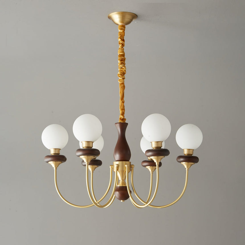 The walnut column and the textured brass stem above it