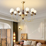 Chandelier lit above a tan sofa in a room with a folding screen