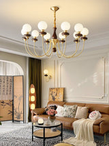Chandelier lit in a pale room above a sofa and a low coffee table