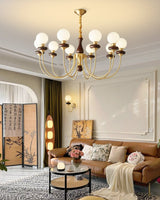 The fitting lit above a sofa and a round table with flowers on it
