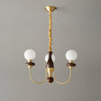The three light build, three white glass balls on a walnut column
