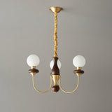 The three light build, three white glass balls on a walnut column