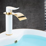 Gold and white waterfall bathroom faucet installed in a bathroom setting