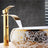 Gold and white waterfall bathroom faucet with deck mounted single handle