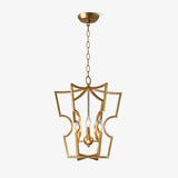 An open brass lantern frame with scalloped sides and four candle lamps inside
