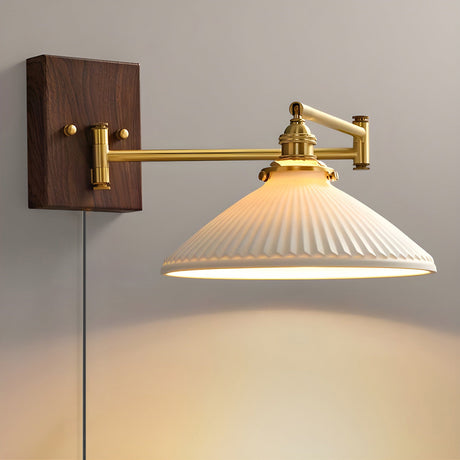 Wide ribbed ceramic dome lit on a brass arm, the cord hanging down