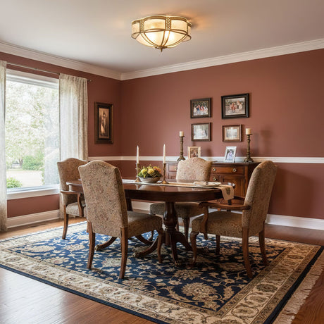 Brass and milk glass ceiling light above a dining table with red walls