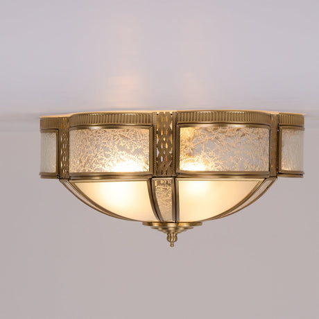 Brass and milk glass ceiling light seen from below, unlit